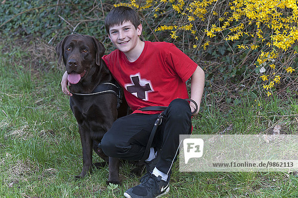 Boy  11 years  with a Labrador  Germany  Europe