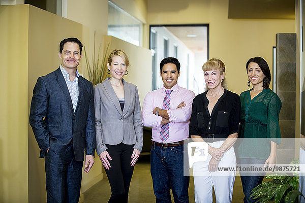 Business people smiling in office lobby