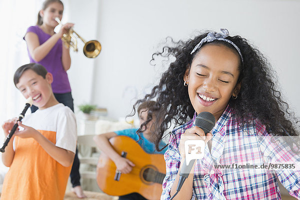 Happy children singing and playing music