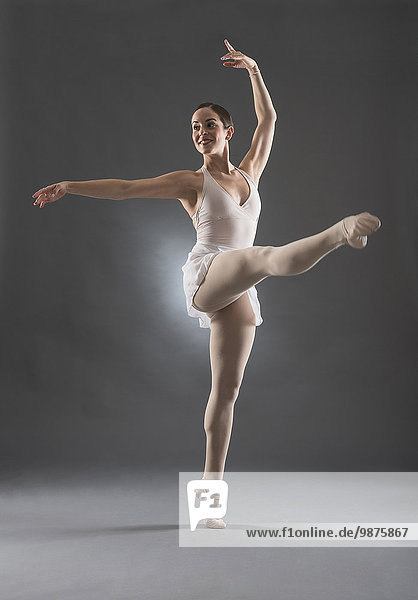 Hispanic ballet dancer posing on tip toe