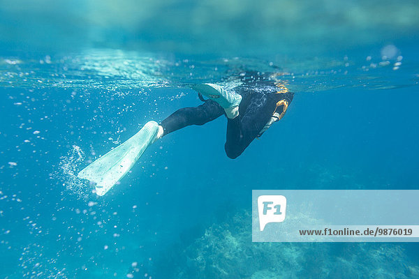 Caucasian woman snorkeling in tropical ocean