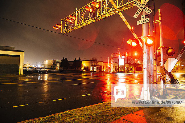 Illuminated traffic lights on railroad crossing at night