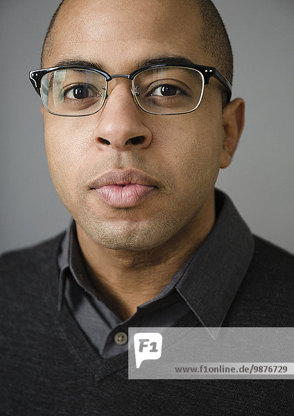 Close up of mixed race man wearing eyeglasses