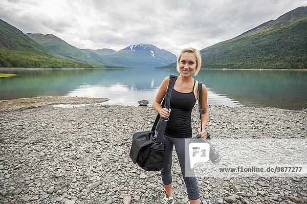 Female photographer at work at Eklutna Lake  Chugach State Park  Southcentral Alaska