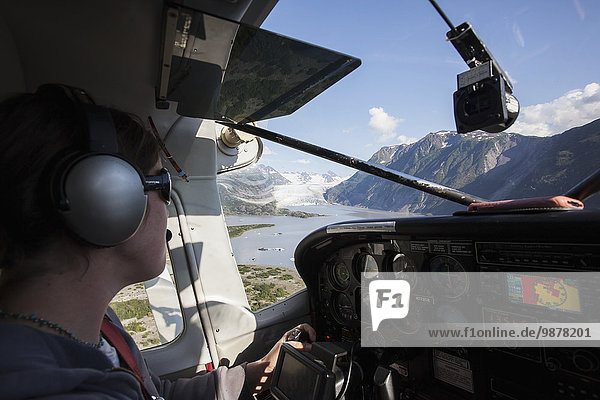 Female pilot flying to Grewingk glacier in Kachemak Bay State Park  Southcentral Alaska.