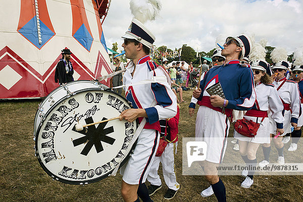 'Fancy dress of a marching band at a music festival; Dorset  England'