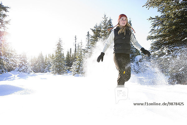 Young Woman On Snowshoes Enjoy The Outdoors Near Homer  Alaska During Winter.