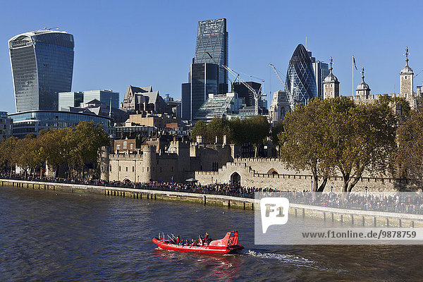 'Rib boat on the River Thames in front of the Tower of London and the buildings of the City of London  the financial district; London  England'