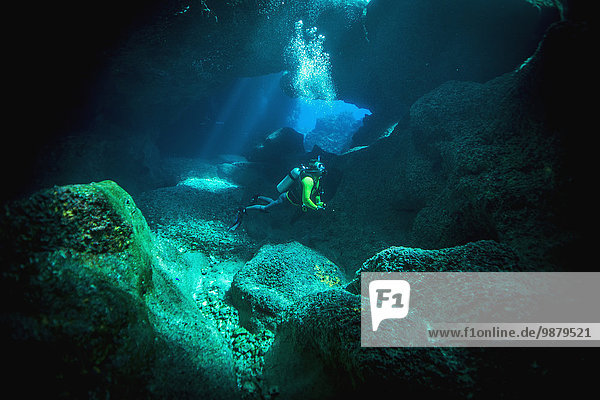 'Diving into one of the underwater caves that surround Niue; Niue Island'