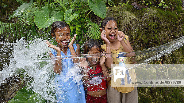 'Timorese children playing with water; Timor-Leste'