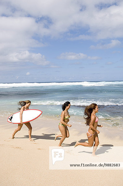 Girls Running On Beach With Surfboard  Maui  Hawaii