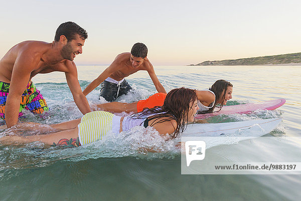 'Group of young friends having fun at the beach  Valdevaqueros beach; Tarifa  Cadiz  Costa de la Luz  Andalusia  Spain'