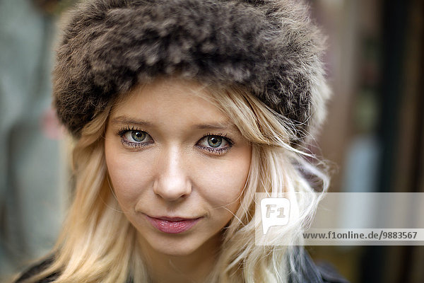 Portrait of blond young woman with fur hat