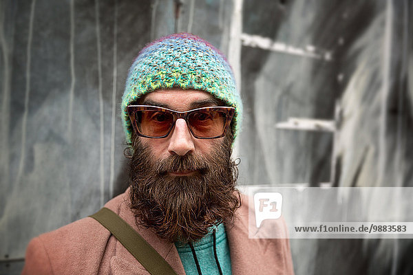 Portrait of bearded mature man with beanie and sunglasses