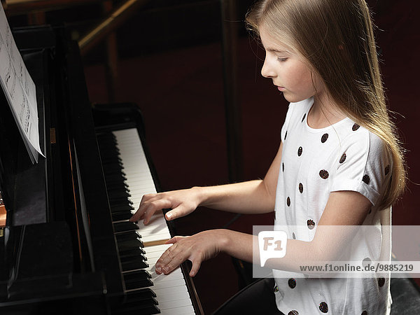 High angle view of girl playing piano