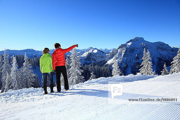 Two women in snow  Tegelberg  Ammergau Alps  Allgaeu  Bavaria  Germany  Europe