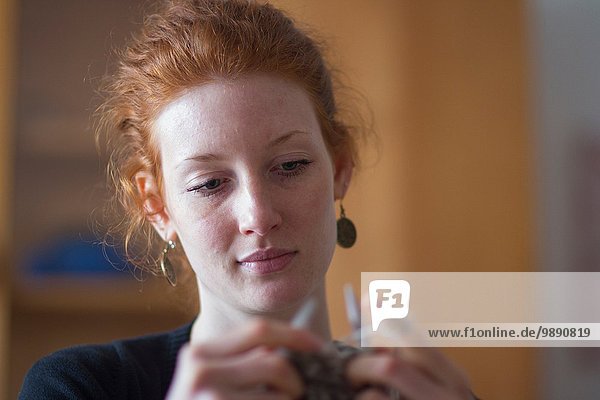 Young woman knitting