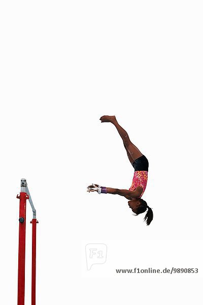 Young gymnast performing on uneven bars