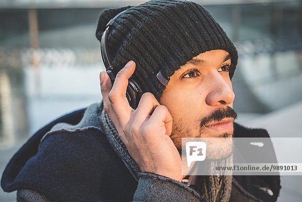 Close up portrait of businessman listening to headphones