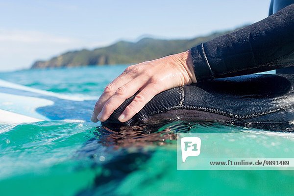 Hands of surfer in the water  Bay of Islands  NZ