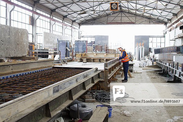 Factory worker on production line in concrete reinforcement factory