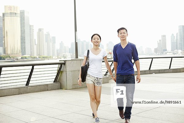 Couple strolling hand in hand on the waterfront  The Bund  Shanghai  China