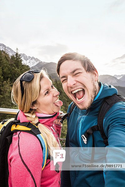 Young hiking couple posing for selfie in mountains  Reutte  Tyrol  Austria