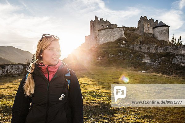 Young female hiker in front of Ehrenberg castle ruins  Reutte  Tyrol  Austria
