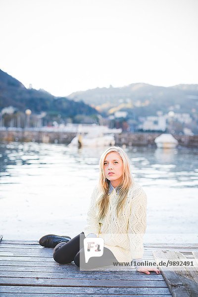 Portrait of young woman on lakeside pier  Lake Como  Italy