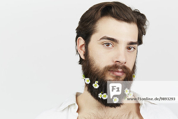 Porträt eines Mannes mit Blumen im Bart