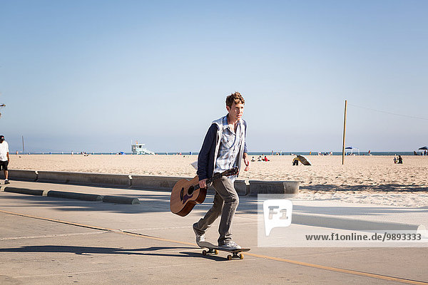 Young man skateboarding  Santa Monica Pier  Santa Monica Beach  US
