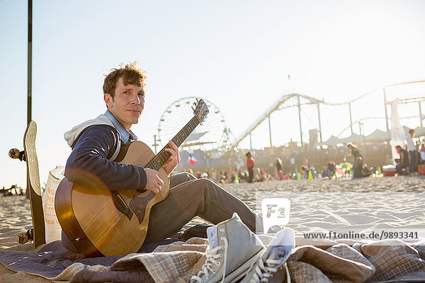 Young man playing guitar  Santa Monica Pier  Santa Monica Beach  US
