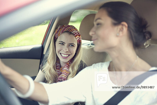 Two female friends on car journey together