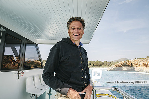Spain  Mallorca  portrait of smiling man standing on a boat