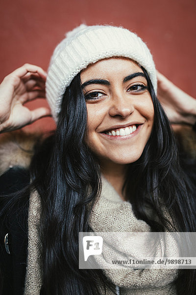 Portrait of happy young woman wearing wool cap