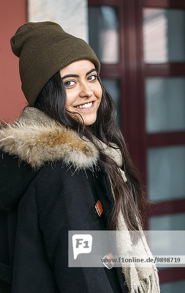 Portrait of happy young woman wearing wool cap