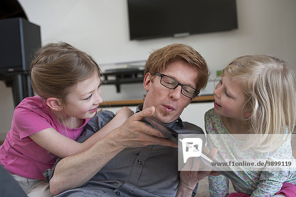 Father with two daughters holding record