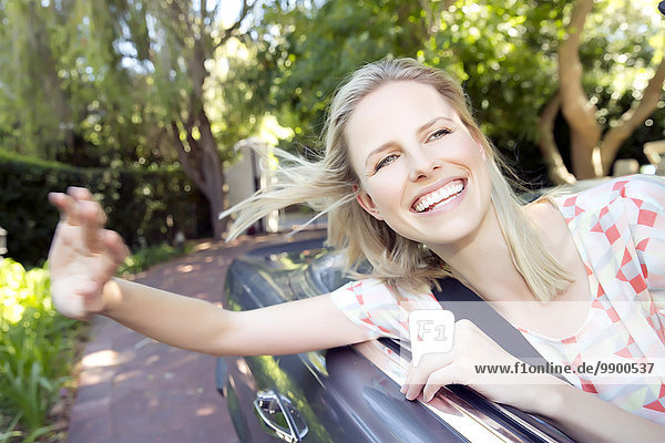 Blonde woman driving in covertible