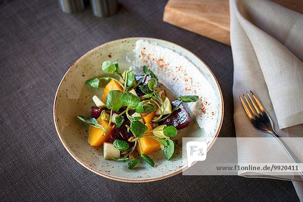 Bowl of salad with beetroot on restaurant table