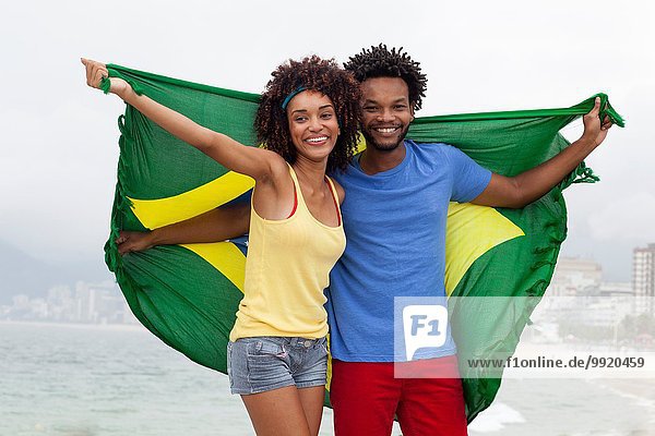 Young Woman Dancing With Brazilian Flag On Ipanema Beach Rio De Janeiro Brazil