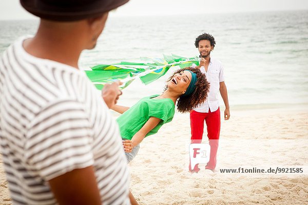 People limbo dancing on beach  Rio de Janeiro  Brazil