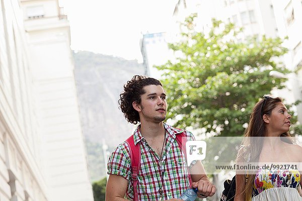 Young couple strolling on street  Copacabana town  Rio De Janeiro  Brazil