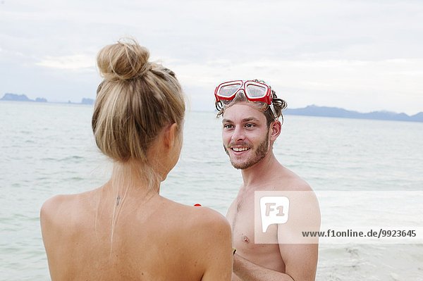 Young couple chatting on beach  Kradan  Thailand