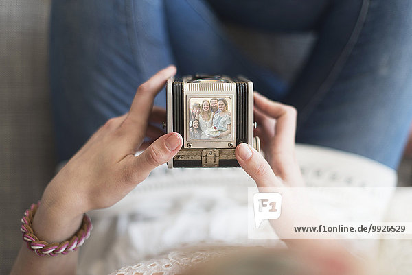 Woman holding antique camera