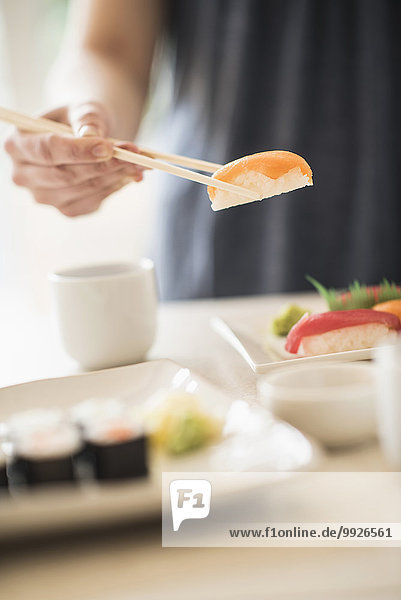 Close-up of woman preparing sushi