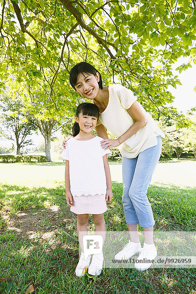 Japanese mother and daughter in a city park