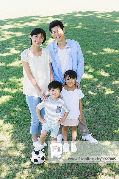 Happy Japanese family in a city park