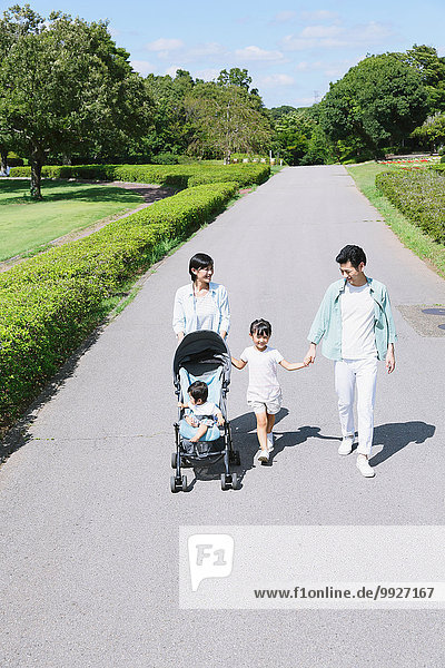 Happy Japanese family in a city park