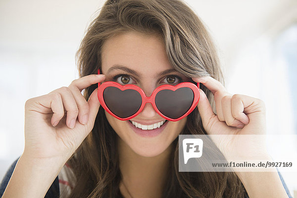 Portrait of woman in heartshaped sunglasses