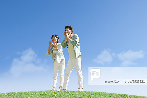 Happy Japanese couple in a park